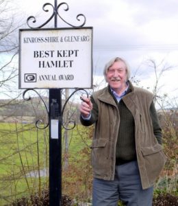 Mike at the Kinross-shire and Genfarg "Best Kept Village" sign.